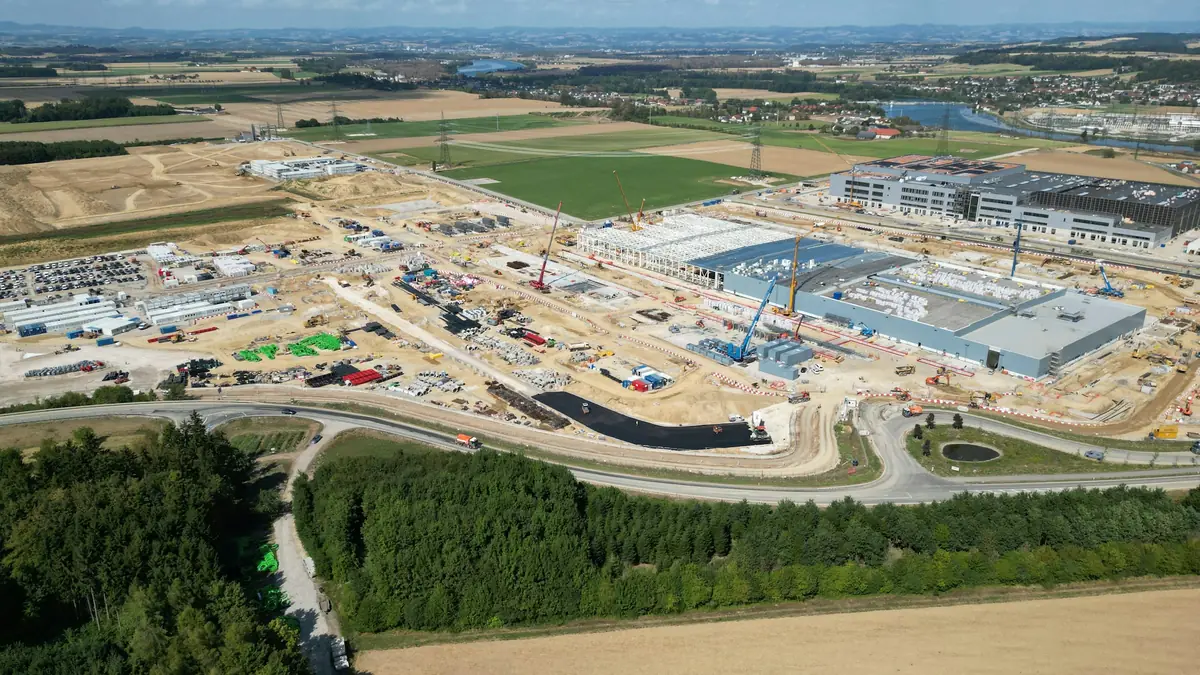 Aerial view of a large construction site with cranes